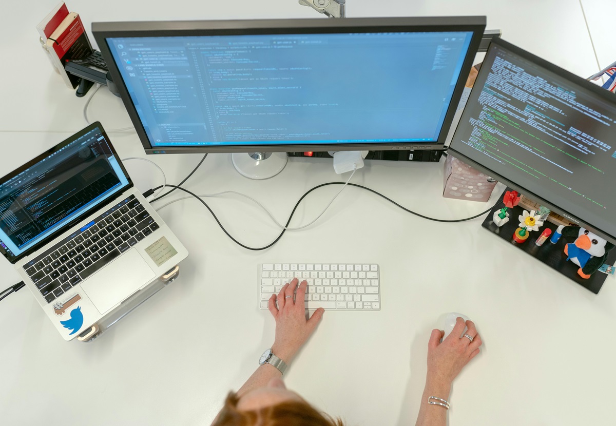 woman looking at computer screen with programming code avoiding a poorly designed website